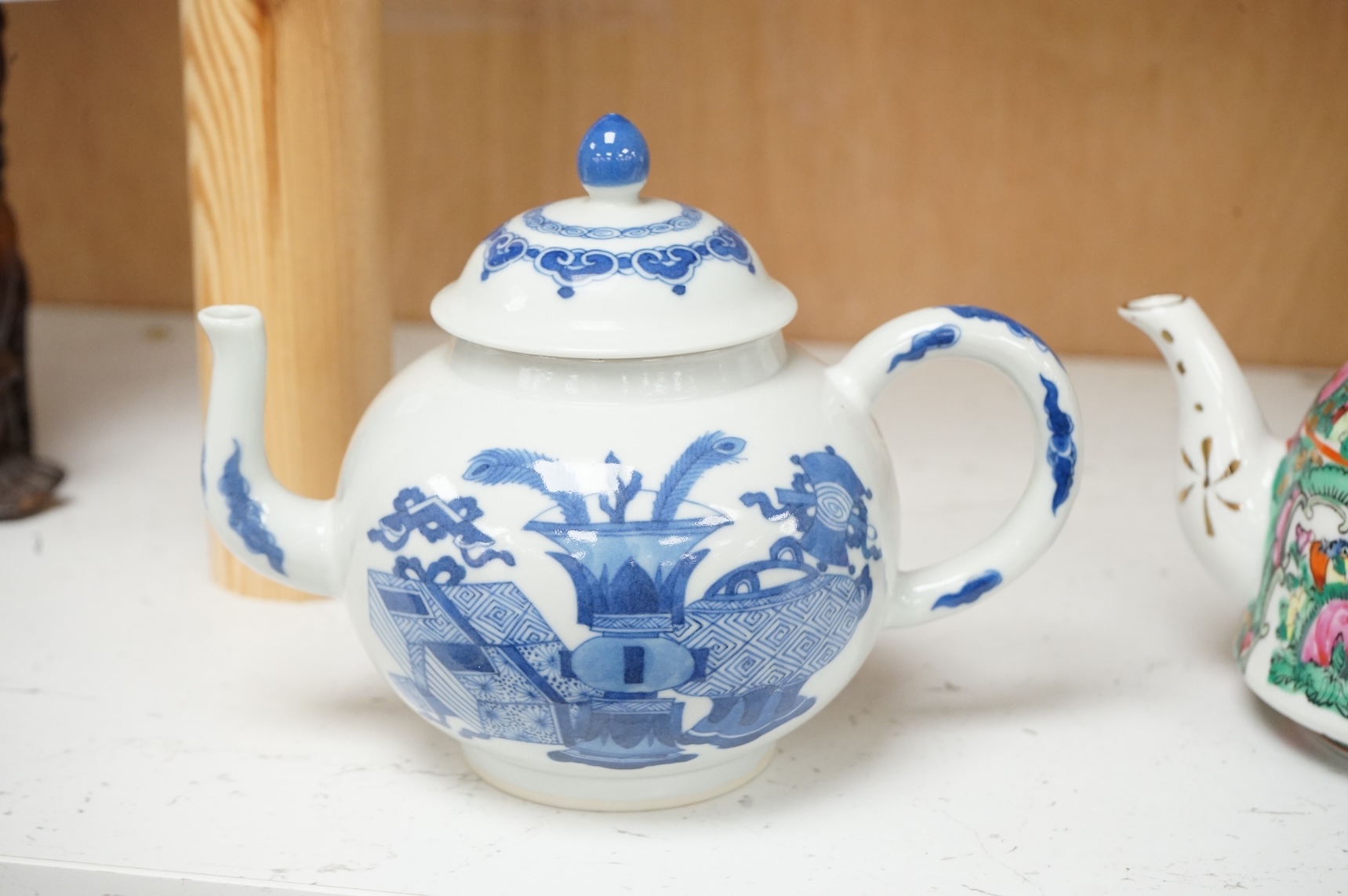 Two Chinese teapots comprising a blue and white and famille rose example, largest 16cm wide